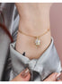 CL/BR05 Bracciale placcata oro giallo con campanella portafortuna azzurra