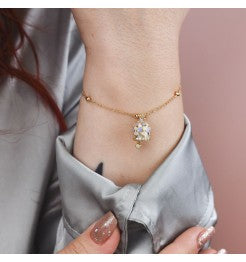 CL/BR05 Bracciale placcata oro giallo con campanella portafortuna azzurra
