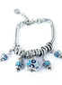 AMO CAPRI - Bracciale in Metallo multiciondoli pendenti con campanelle azzurre e cristalli luminosi